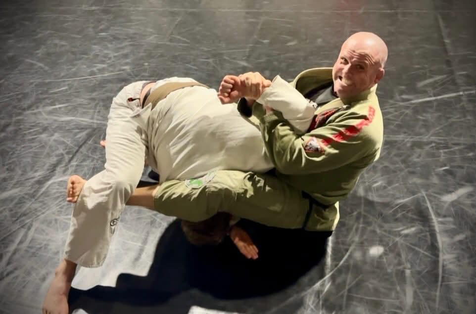 Head coach Mick Moloney attacking from guard on the mats